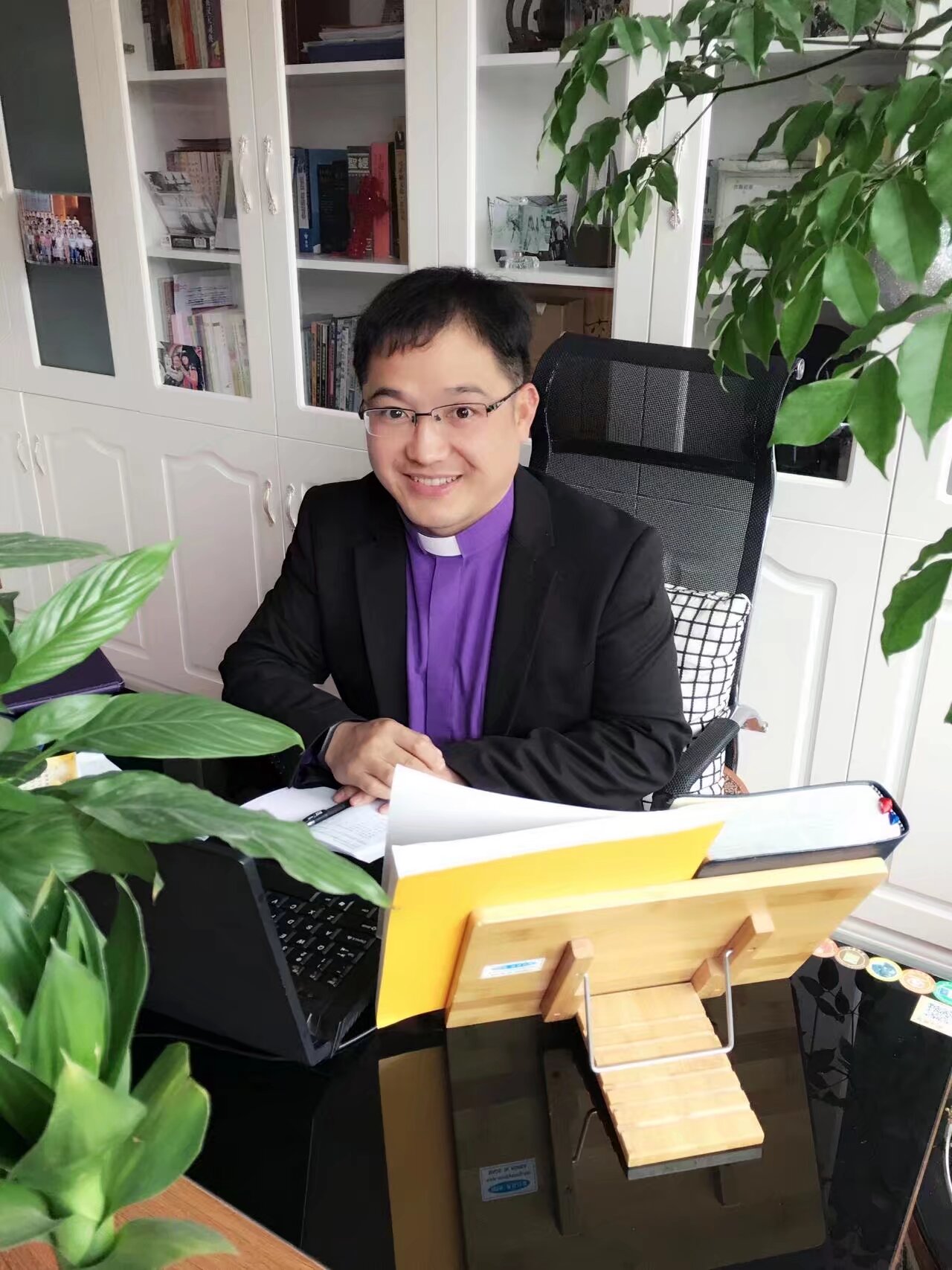 Paul Zhang in a pastoral study setting